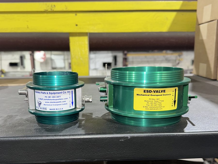 Anodized aluminum KilAire shutdown valves, 3 inch and 5 inch, side by side on a shop bench